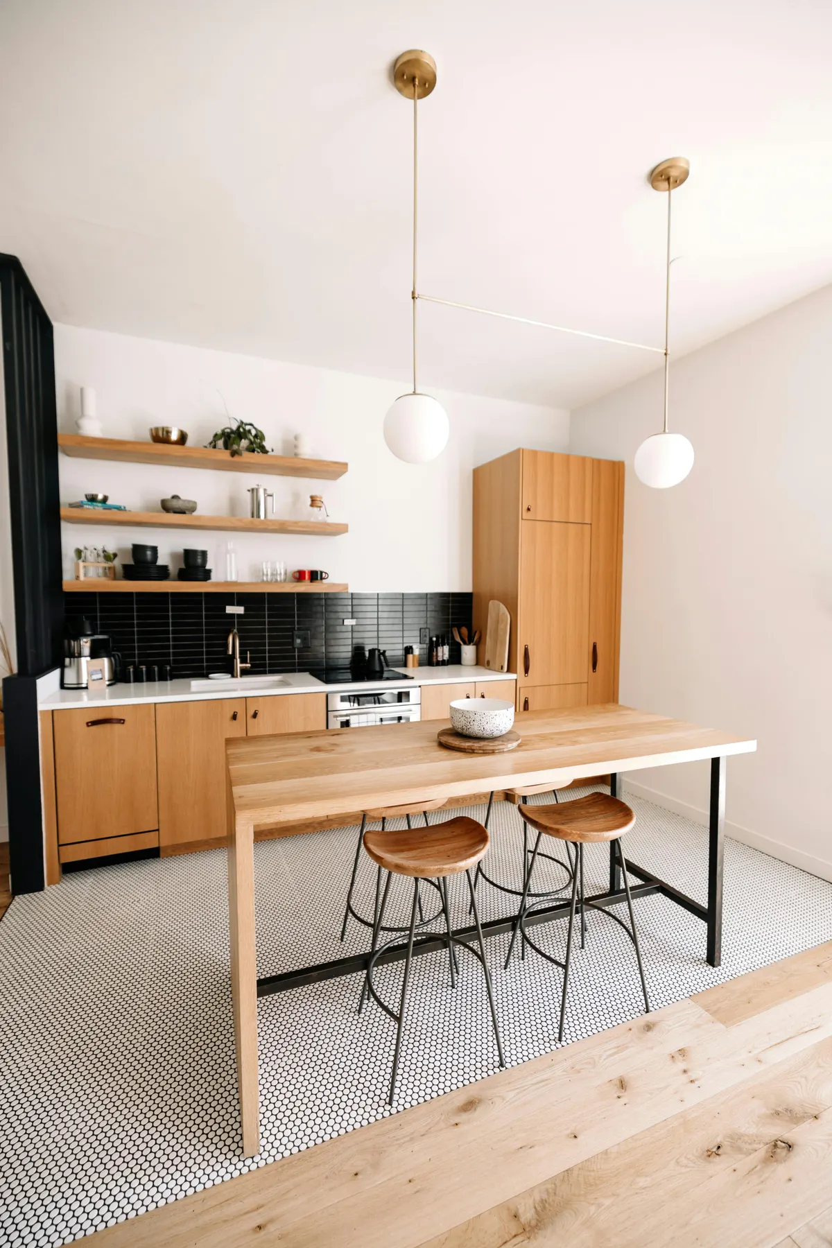 Modern kitchen with island and pendant lighting in Kensington Calgary
