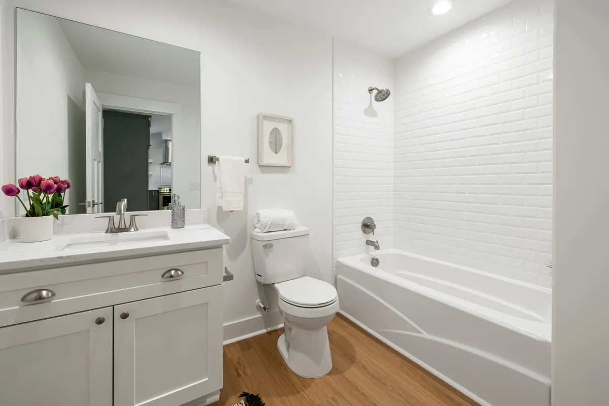 Clean white bathroom renovation with vanity in Mount Royal Calgary